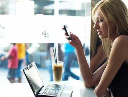 Lady enjoying a coffee and talking on the phone in a conference call