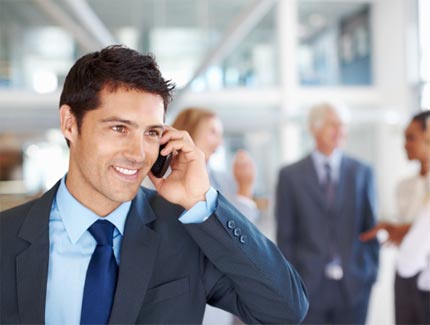 Business man on the phone taking part in a conferencce call.